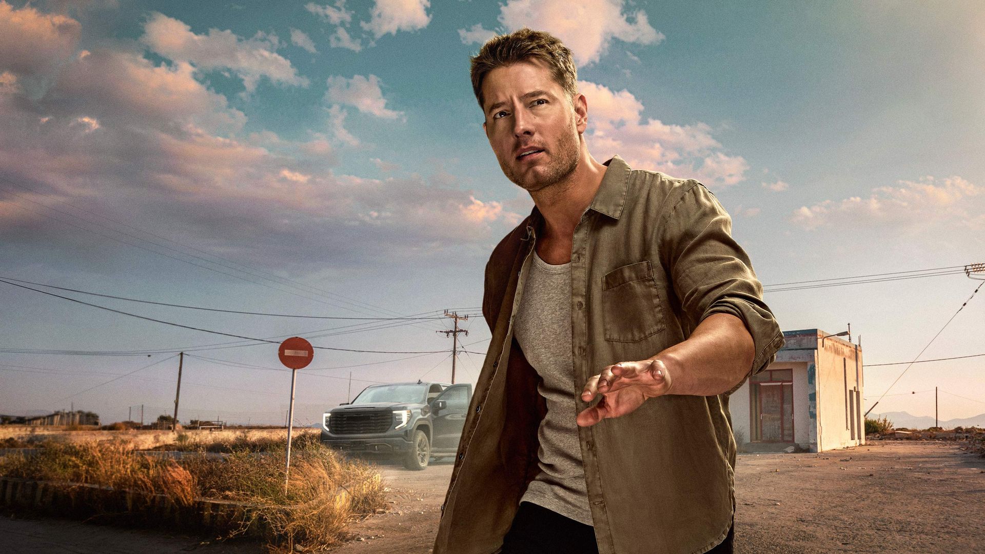 Justin Hartley as Colter Shaw standing outdoors in a promotional image for Tracker Season 4