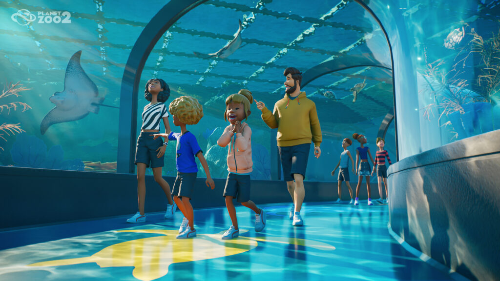 Guests walking through a glass tunnel aquarium with aquatic animals in Planet Zoo 2