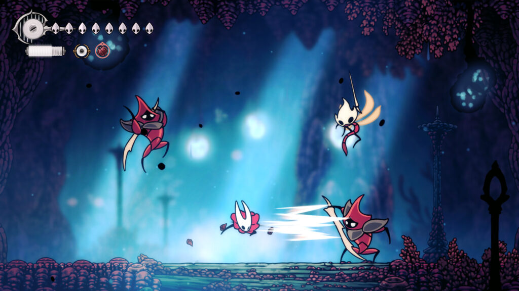 Hornet fighting red-armoured bugs in a blue cavern in Hollow Knight: Silksong