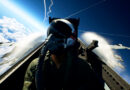 A fighter pilot in the cockpit high above the clouds in Ace Combat 8: Wings of Theve