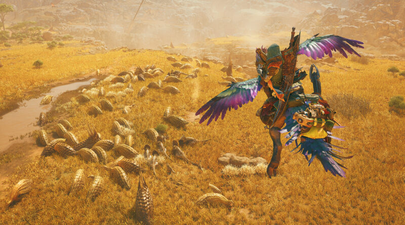 A hunter rides through golden grassland past a herd of armored creatures in Monster Hunter Wilds