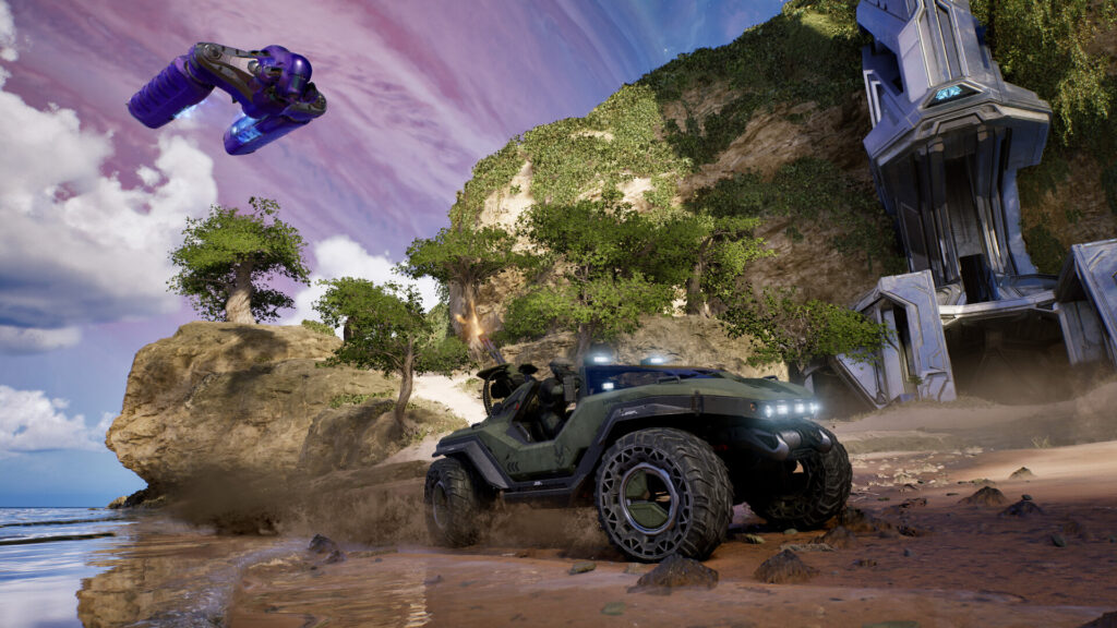 A Warthog drives across the green landscape of the Halo ring in Halo: Campaign Evolved