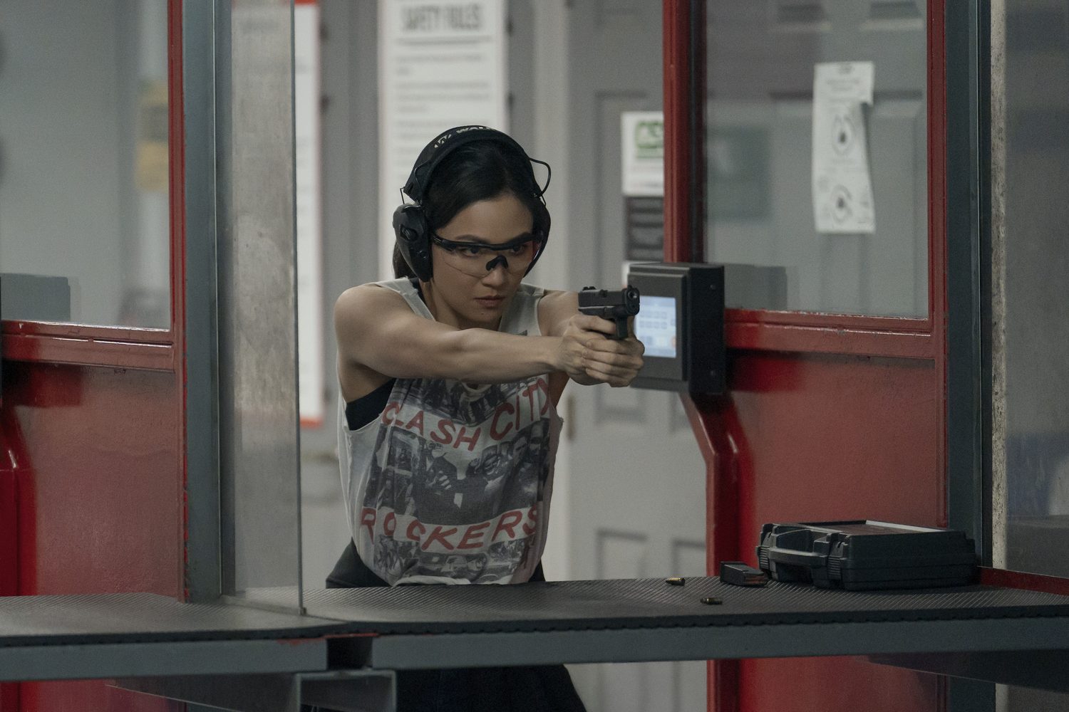 Constance Wu as Katie Buranek aiming a pistol at a shooting range in The Terminal List Season 2